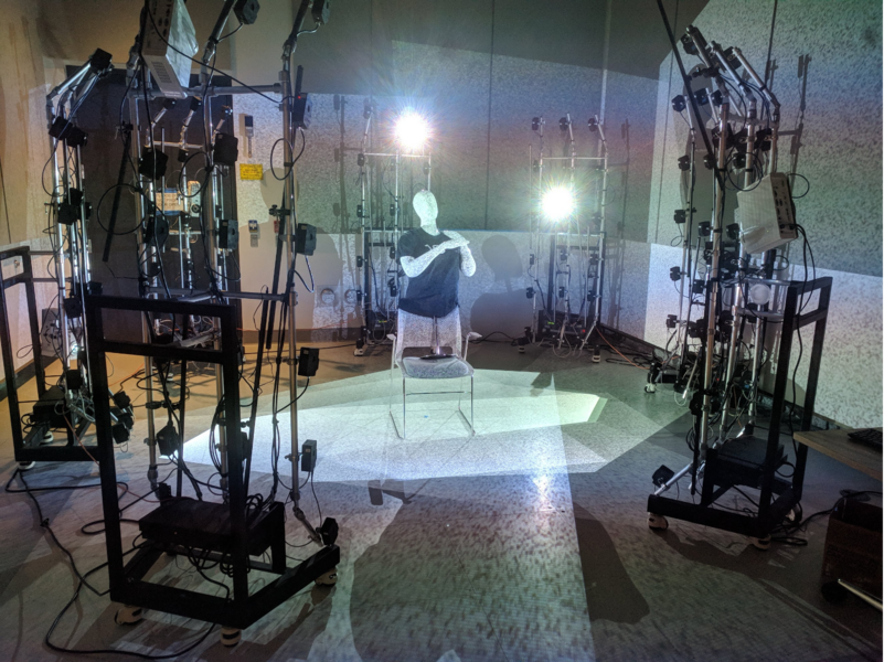 Photo of a humanoid figure surrounded by the Lenscloud photogrammetry system