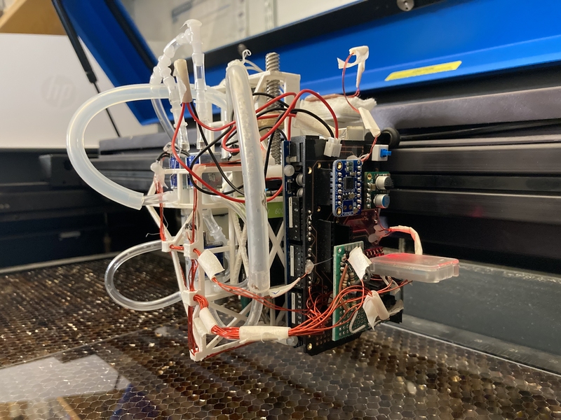 Photo of a small (~foot-wide) device bristling with wires, tubes, and computer chips