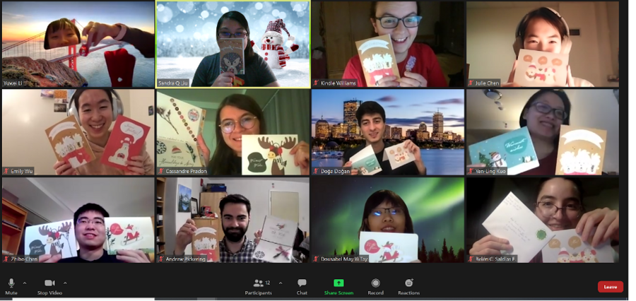 Screenshot of Sidney Pacific graduate community members smiling in a Zoom room and holding up written cards