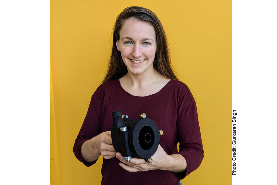 Photo of Hilary Johnson holding her variable volute pump and smiling