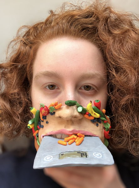 Woman wearing mask art with 3D food motif