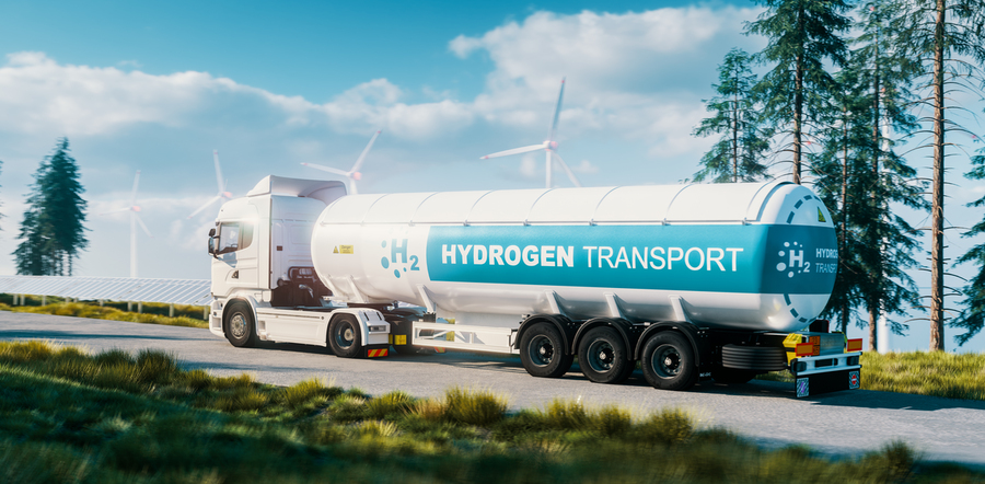 Illustration of a white fuel truck that says "hydrogen transportation" on it, driving down a road past pine trees, solar panels, and wind turbines. 