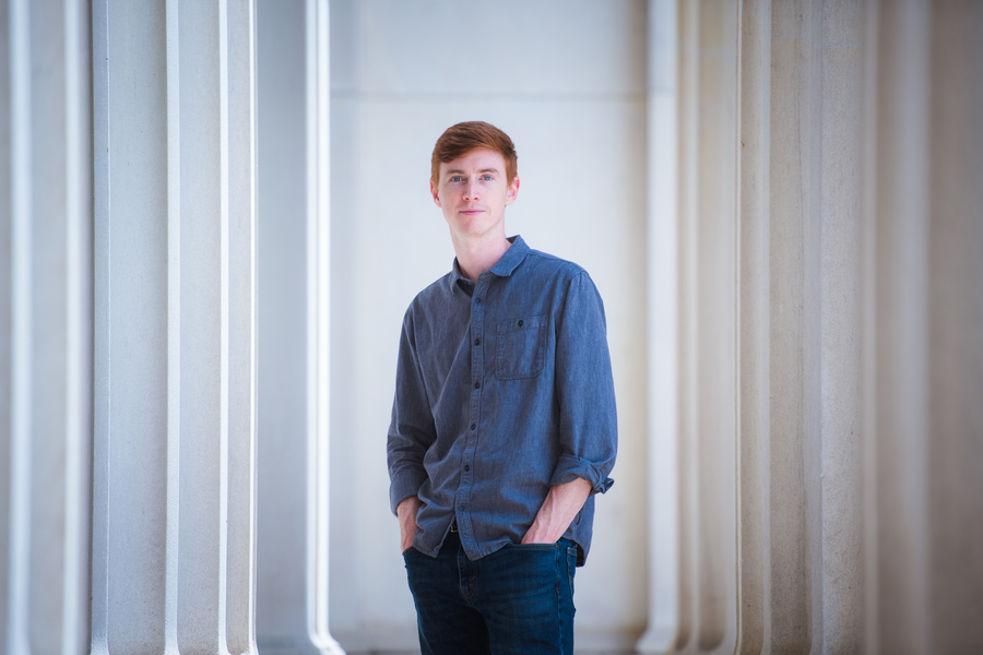 Photo of W. Robb Stewart wearing jeans and a denim shirt, standing with his hands in his pockets