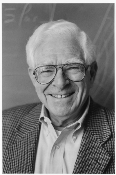 Black and white portrait photo of Professor Emeritus Ronald Probstein, smiling at the camera