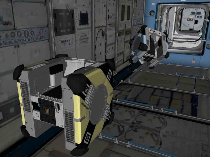 Simulated image of cube-shaped Astrobee robots traveling through a tunnel-like passage way on the ISS.