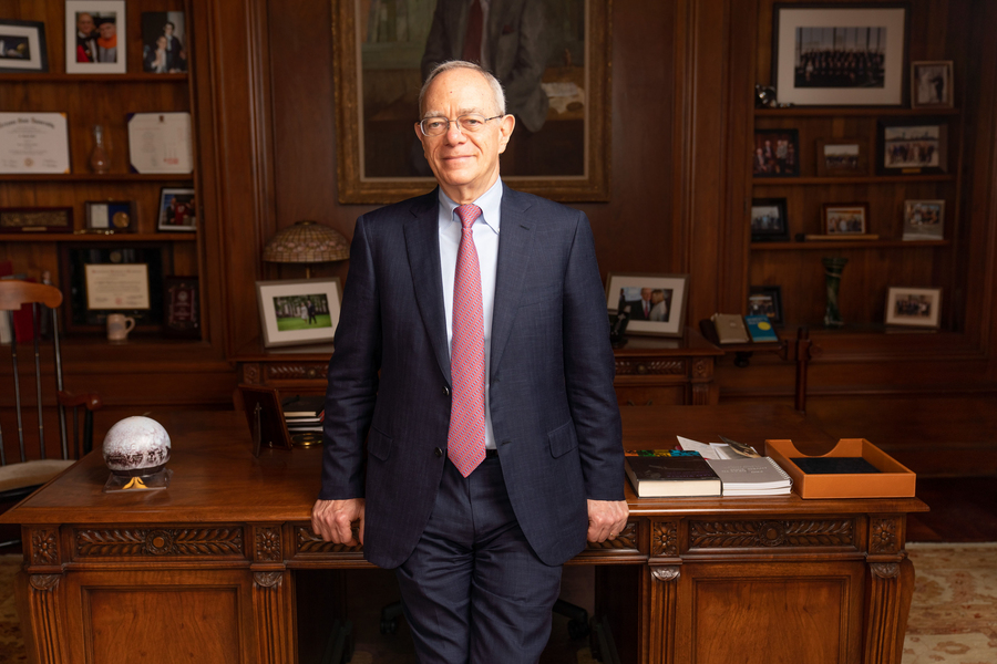 Rafael Reif stands in front of his desk in his MIT office