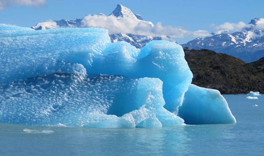 Photo of a large chunk of blue glacial ice that calved off.