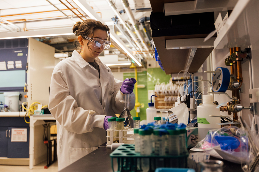 Image of a researcher in a lab preparing solutions for experiments. 