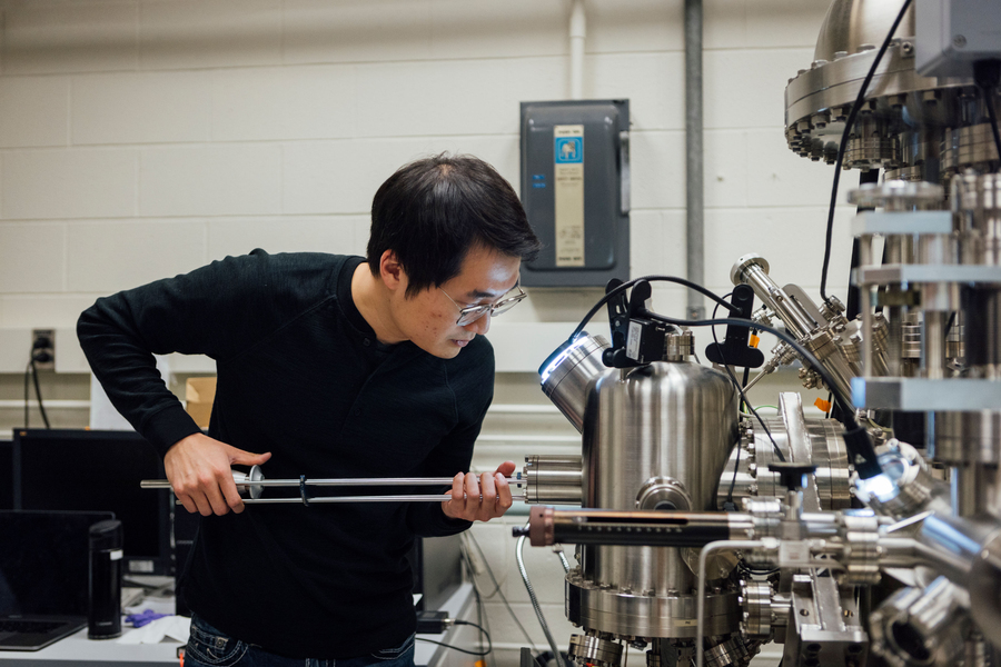 Image of a PhD student in a lab using a scanning tunneling microscope.