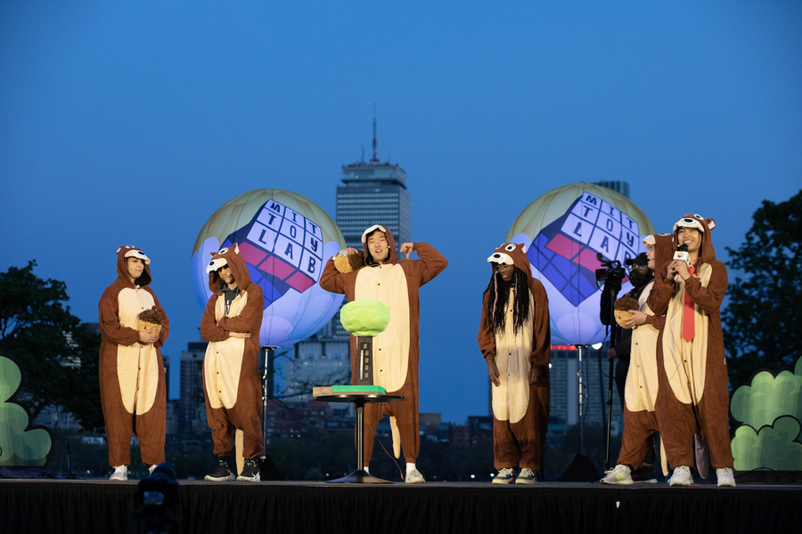 Six or seven students in squirrel costumes present on stage