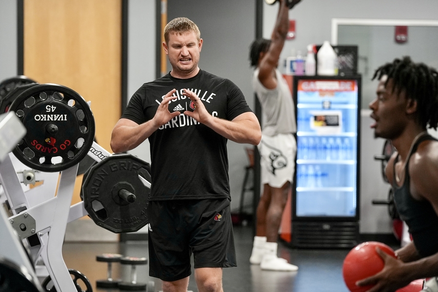 Photo of Adam Petway working with athletes in the gym