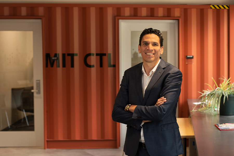 Josué C. Velázquez Martínez stands outside an office that looks like a shipping container and says "MIT CTL.” 