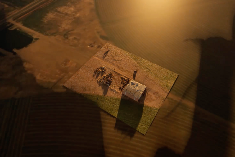 A computer-generated satellite view of a farm structure and surrounding dry brown land
