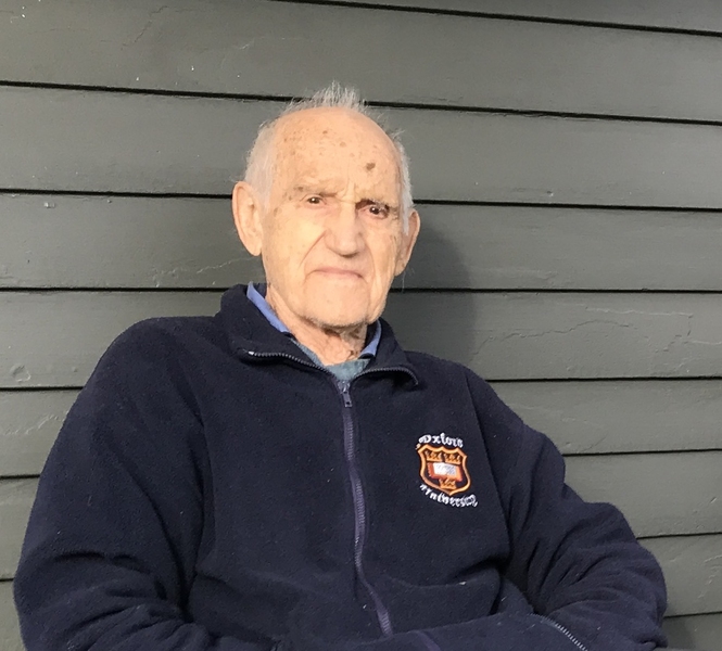 Photo of an older Robert Balluffi, sitting outdoors, leaning against a house