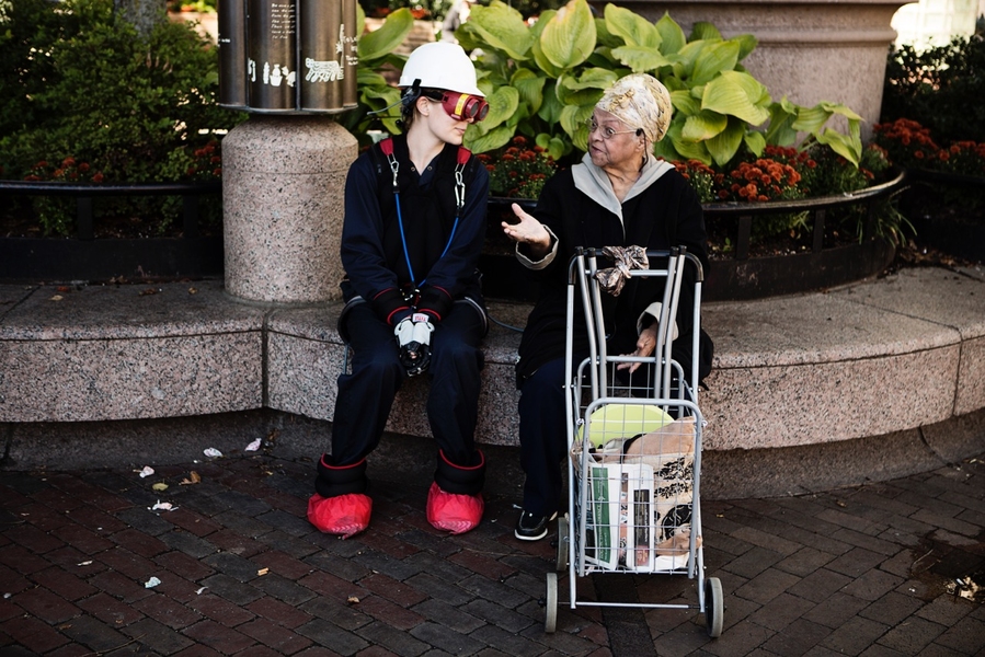 A younger woman wearing the AGNES suit sits next to older woman on a bench