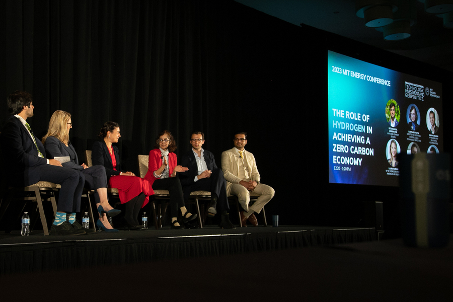 Six people sit on stage in conversation. Sunita Satyapal, in center, is speaking. A screen in the background says, “The Role of Hydrogen in Achieving a Zero Carbon Economy.”