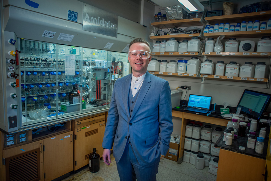 Portrait photo of Bradley Pentelute standing in a chemistry lab