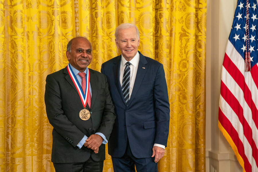 Subra Suresh, left, poses with President Joe Biden while wearing a gold medal