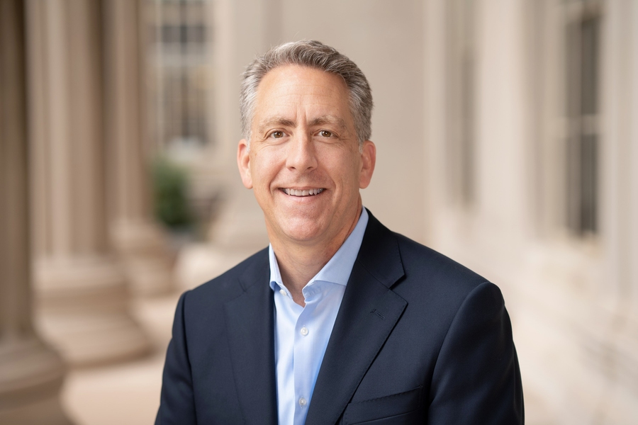 Ian Waitz posing in a jacket and open-collar shirt