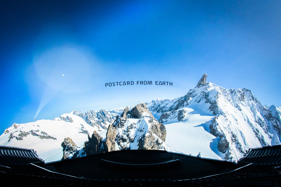 Curved theater screen with snowy mountain vista