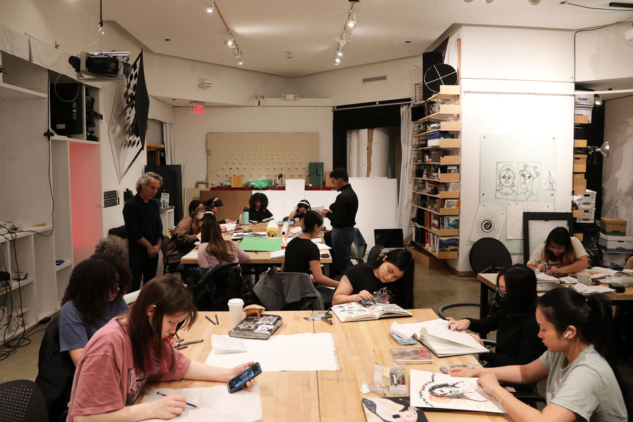 Students work on their projects in an art gallery.