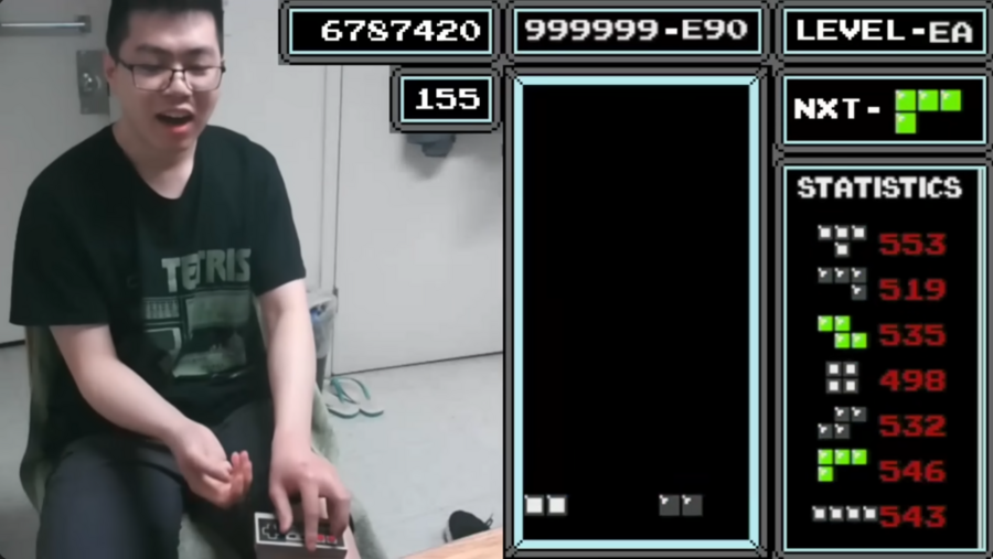 A split-screen shows two halves of a video game screen. On left, Justin Yu responds to his game with shock; on right, the game screen itself shows only two blocks.