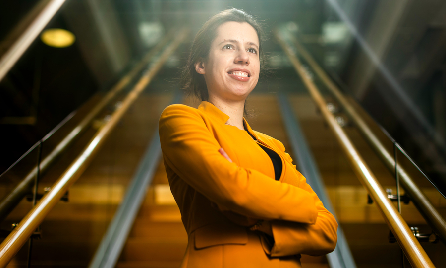 Taken from below, Netta Engelhardt stands with stairs behind her, retreating into the distance.