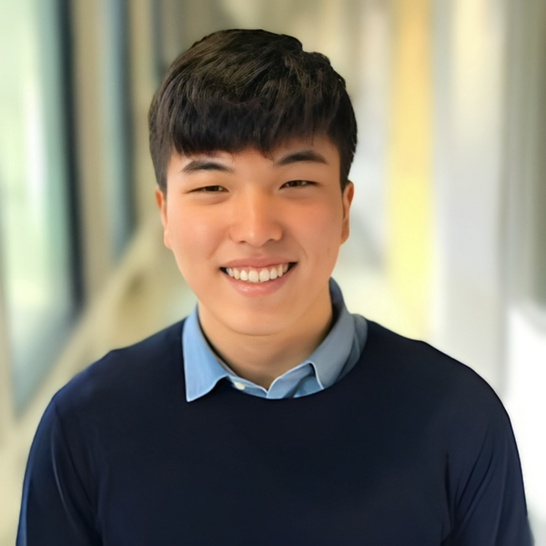 Man with short hair smiling.