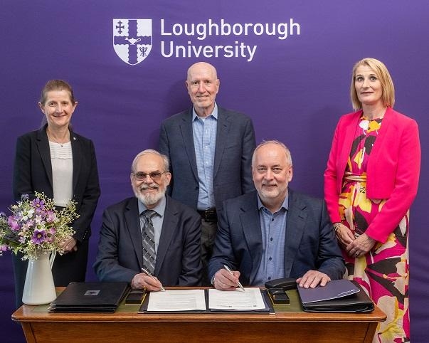 Rachel Thompson, Eric Grimson, Yossi Sheffi, Nick Jennings, and Jan Godsell pose at an agreement signing ceremony. The words "Loughborough University" are on the wall behind them.