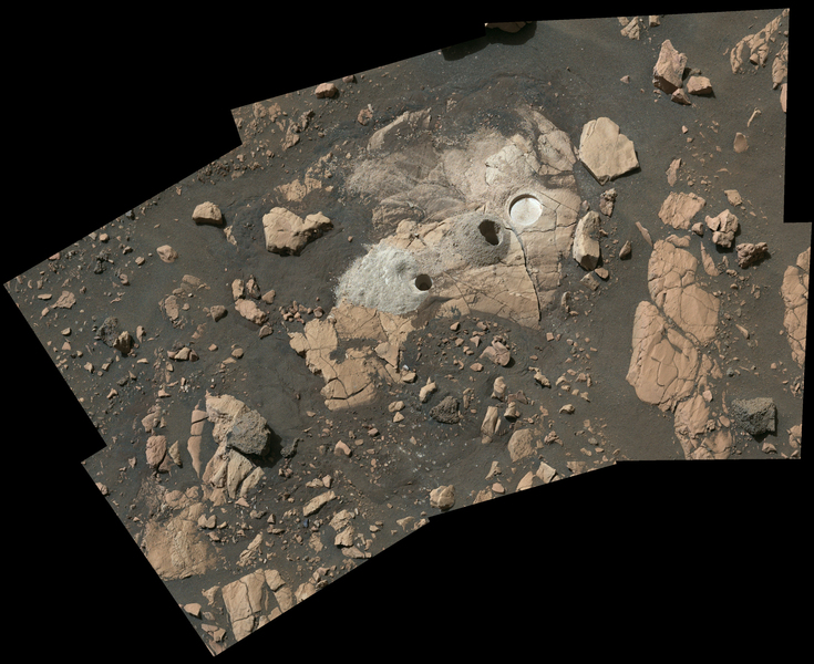 Aerial view shows the brown and tan landscape of Mars. Circular holes show where the rover extracted samples.
