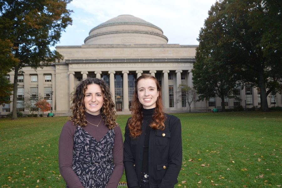 Kelsey Pittman and Jacqueline Orr stand in front of the MIT Dome on the grass of Killian Court