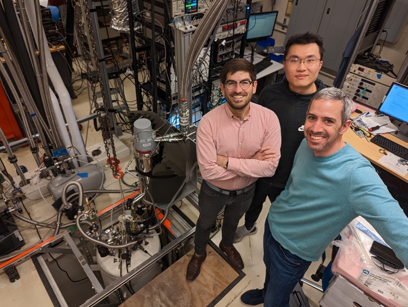 three physicists in their lab