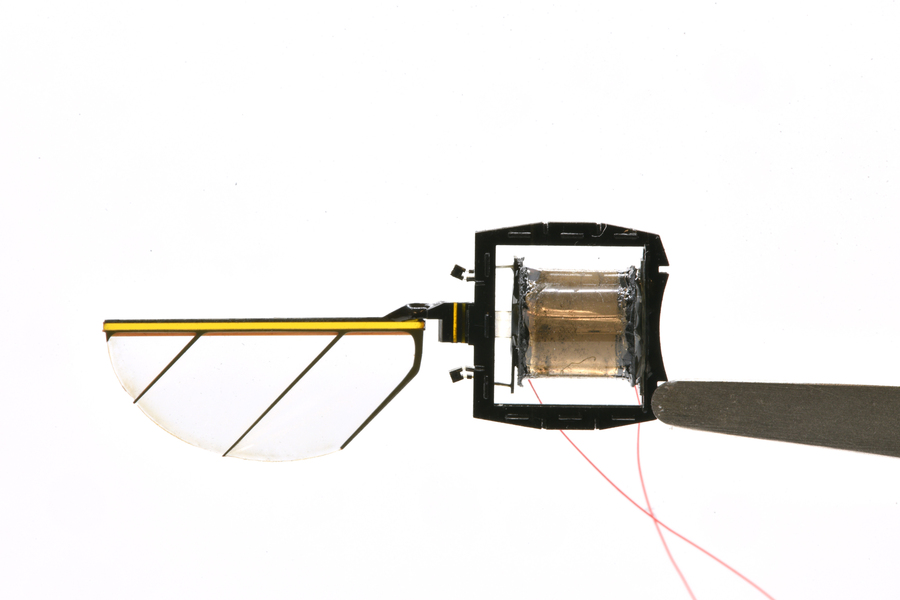 A close-up of the half-circle transparent wing and glued-together black base.