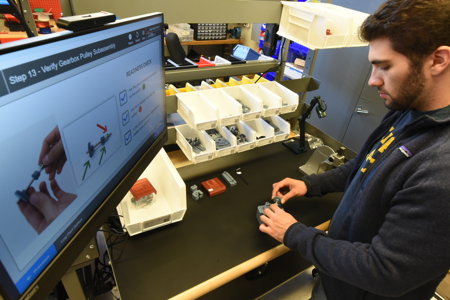 Kayra Ilkbahar follows on-screen directions to assemble a FrED
