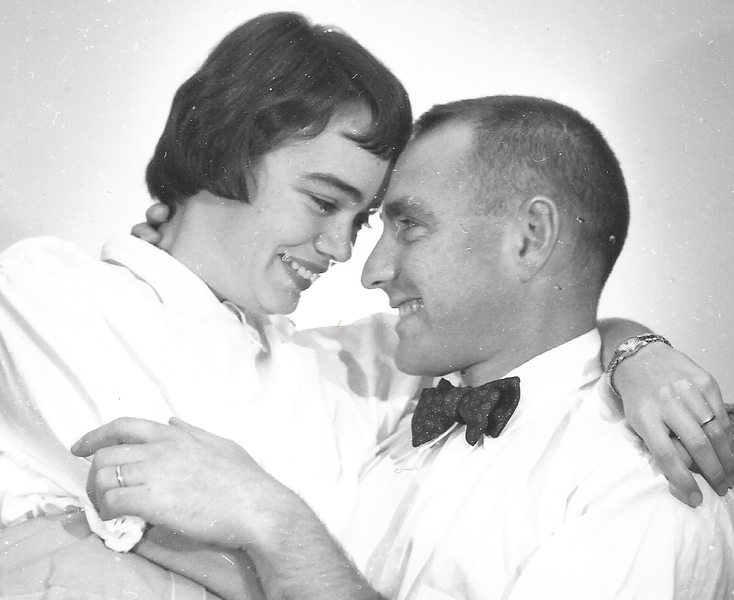 Grayscale photo of Lulu and Lee Grodzins smiling at one another, foreheads touching