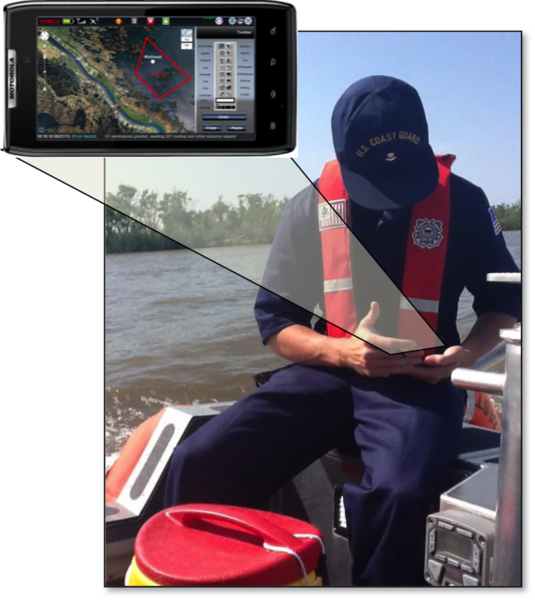 A man on a boat looks down at a smartphone. 
