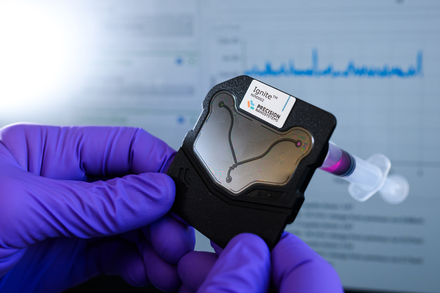 A microfluidic device held by gloved hand