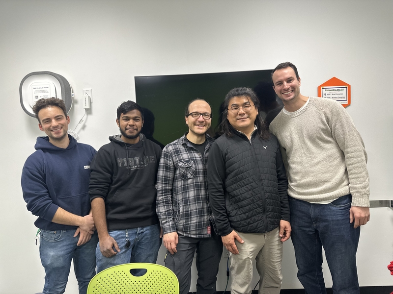 Ben Thomson, Denny Jerald, Lutfi Agartan, Junghyo Yoon, and Bruce Crawford pose together in a white room