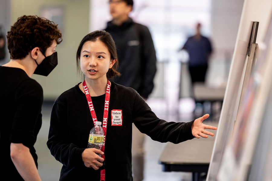 Rhoda Zhang presenting her poster to one other person