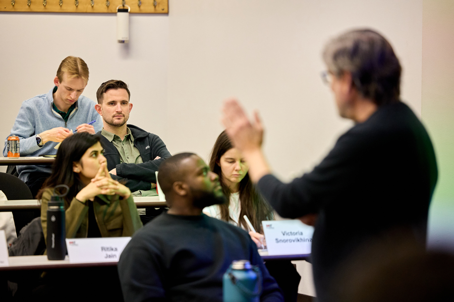 David Brown and several other students listen to a professor lecture in a classroom.
