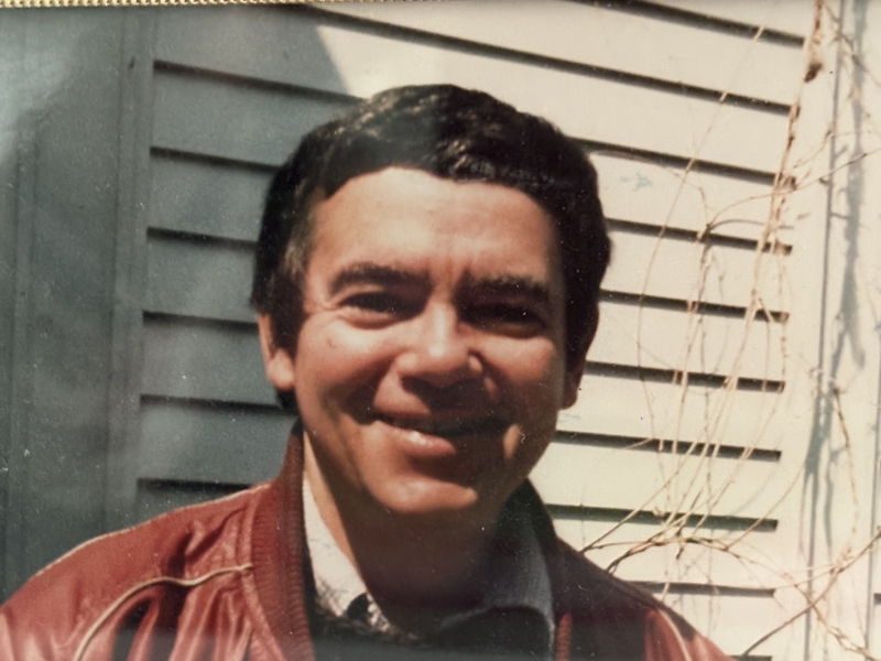 Photo of a young Keith Johnson standing in front of a house