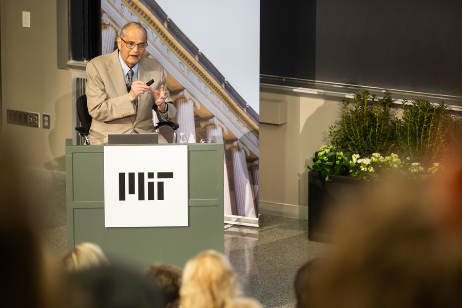 John Joannopoulos speaks at podium on stage.
