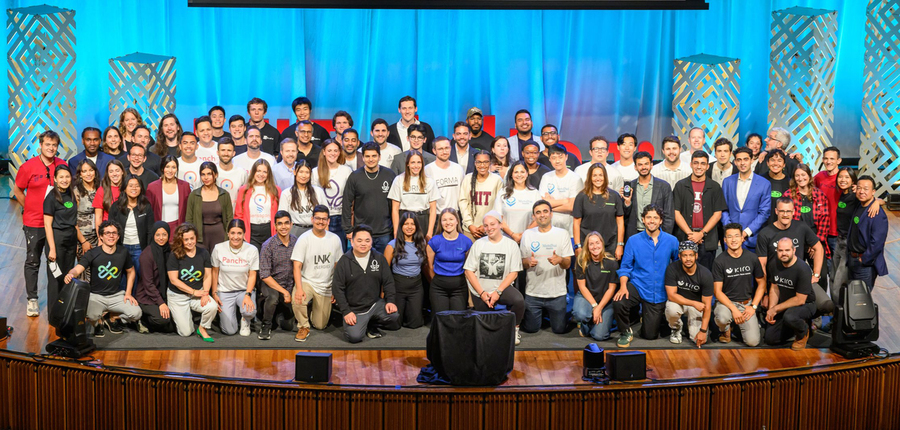 Over 50 people pose for a group photo.