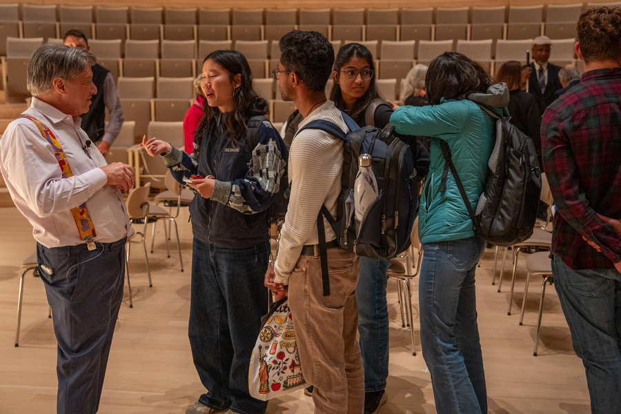 About five people line up to chat with Ray Kurzweil.