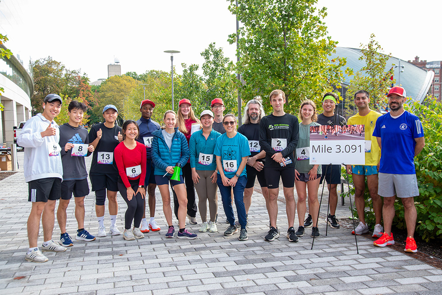 16 MIT students pose for a photo at the finish line of the DMSE 3.091 Fun Run.