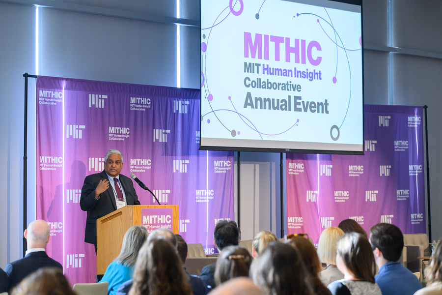 Anantha Chandrakasan speaks from a lectern; the term “MIT Human Insight Collaborative” is displayed on a screen behind him