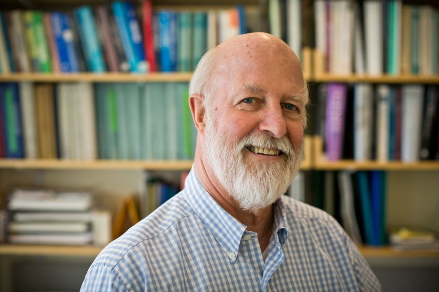 Richard Hynes in an office with bookshelves in back