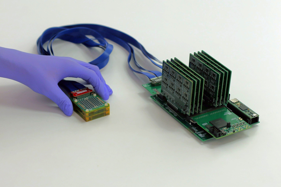The complete setup shows, on left, the ultrasound prototype connected by wires to exposed circuit boards.