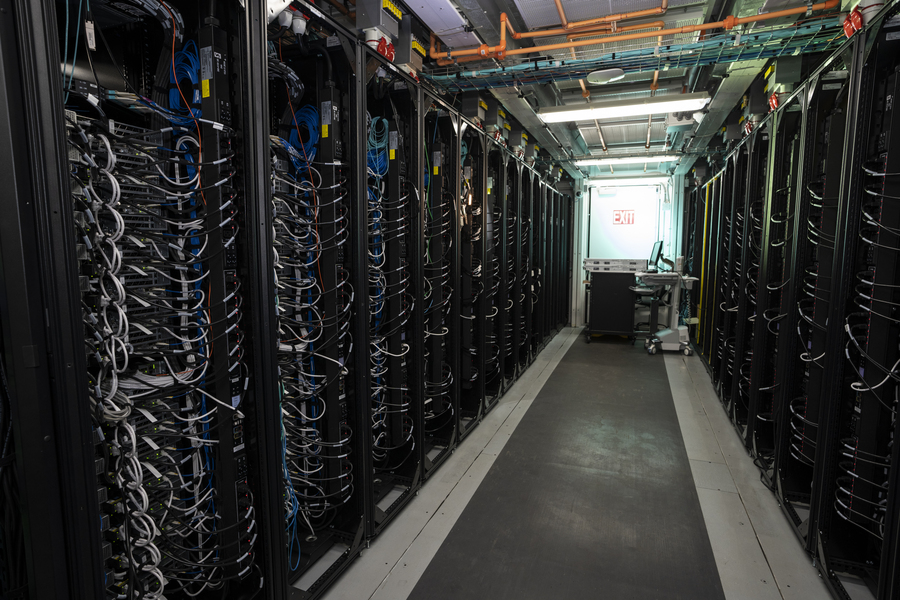 Two rows of server racks inside a data center
