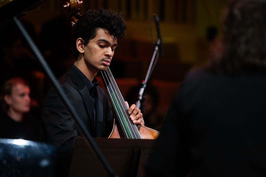Close-up of a student playing a bass violin during a performance